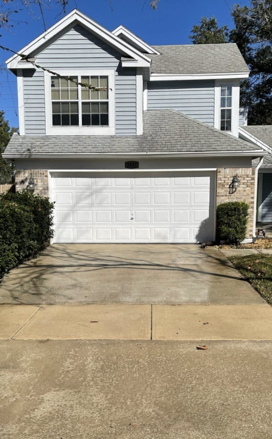 After: Driveway cleaning before and after showing oil stain removal