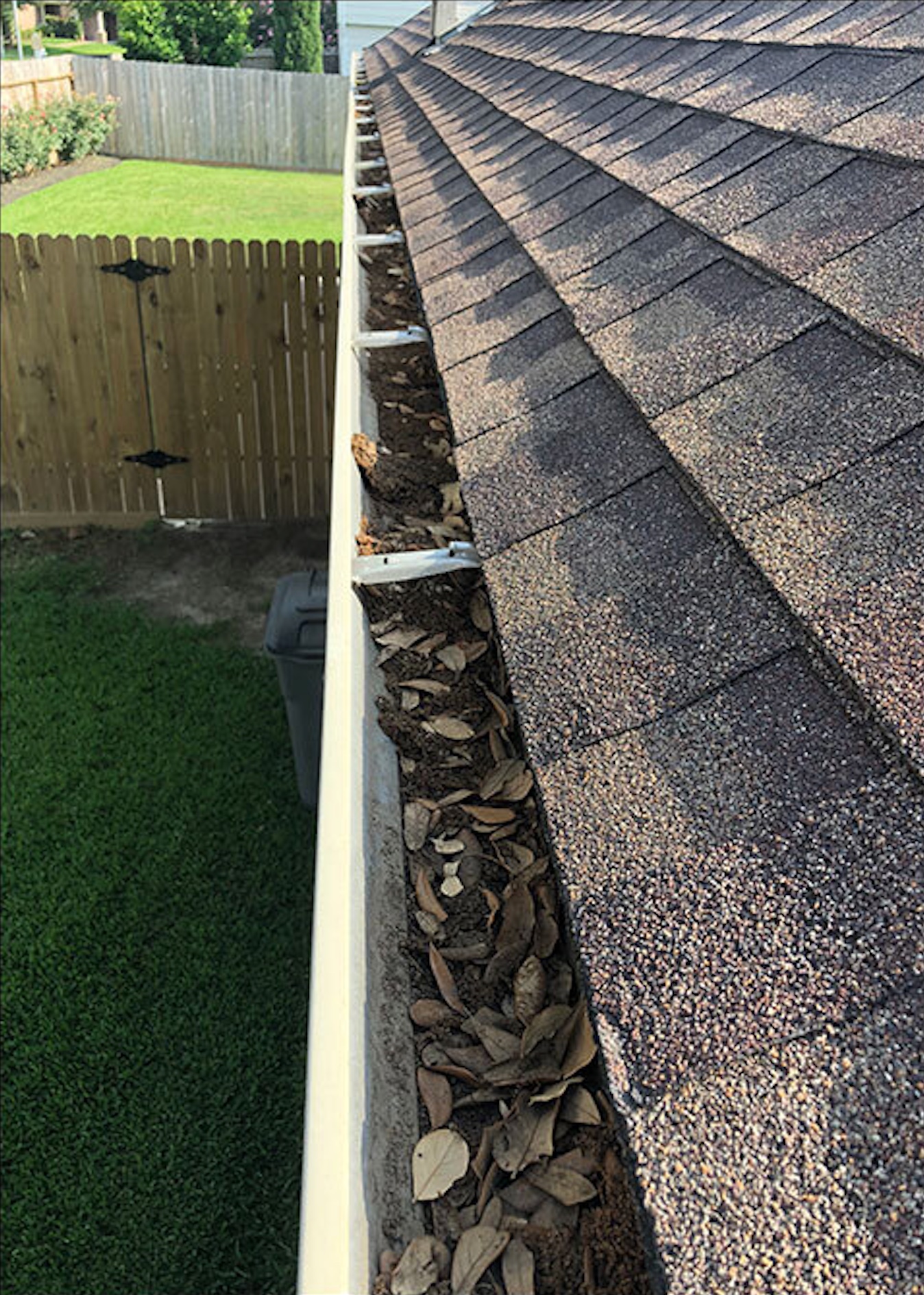 Before: Gutter cleaning before and after showing debris removal and brightening